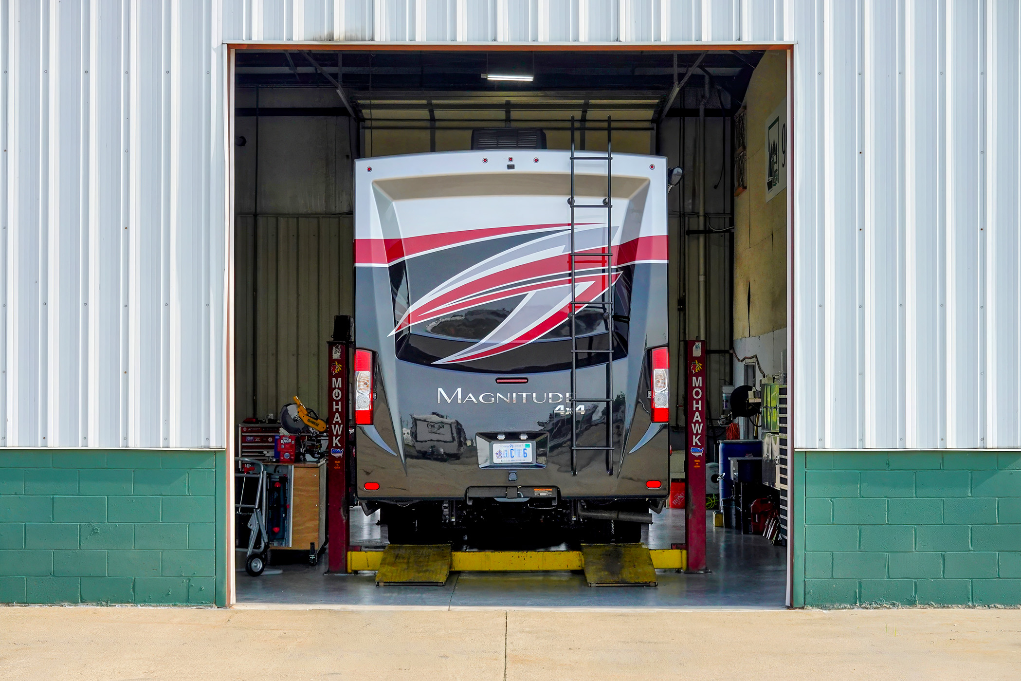 RV in the open door of a repair bay
