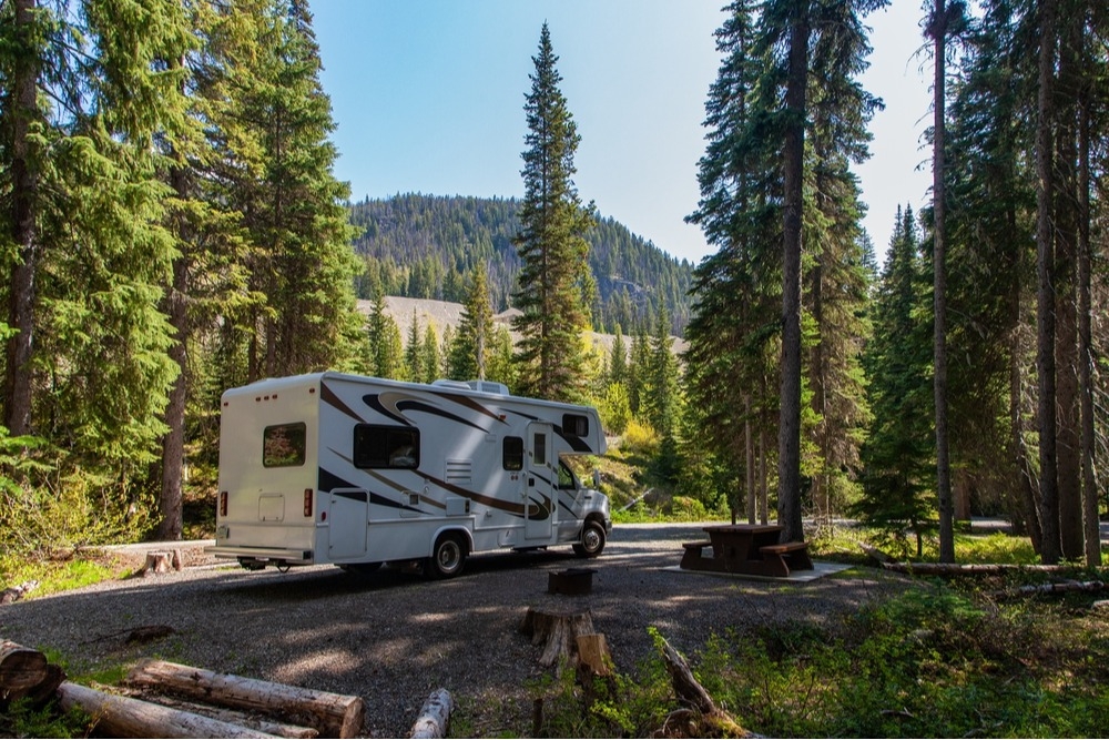 RV parked at a campsite in the foothills on a sunny day
